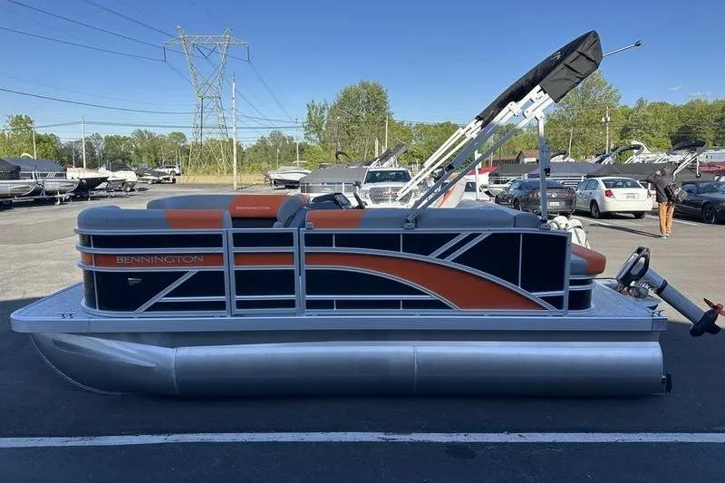 Slide: The Image of 2026 Bennington S L-Bench 168 SLJ pontoon boat in a parking lot. - 12