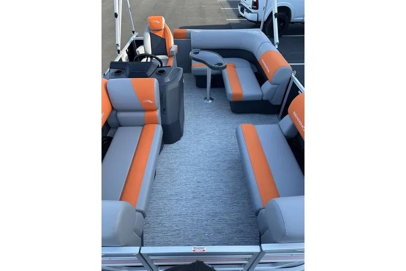 Slide: The Image of 2026 Bennington S L-Bench 168 SLJ pontoon boat interior with orange and gray seating. - 3