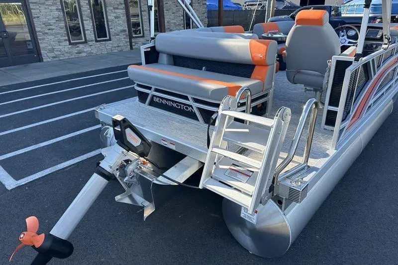 Slide: The Image of 2026 Bennington S L-Bench 168 SLJ pontoon boat with orange and gray seating. - 5