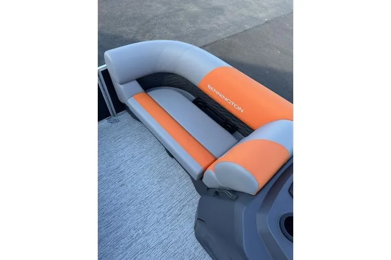 Slide: The Image of 2026 Bennington S L-Bench 168 SLJ with orange and gray seating on a boat deck. - 9