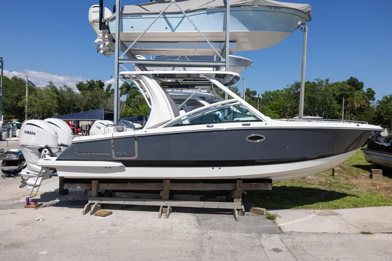 The Image of 2022 Chaparral 300 OSX boat on display, featuring Yamaha engines, in a sunny outdoor setting. - 0