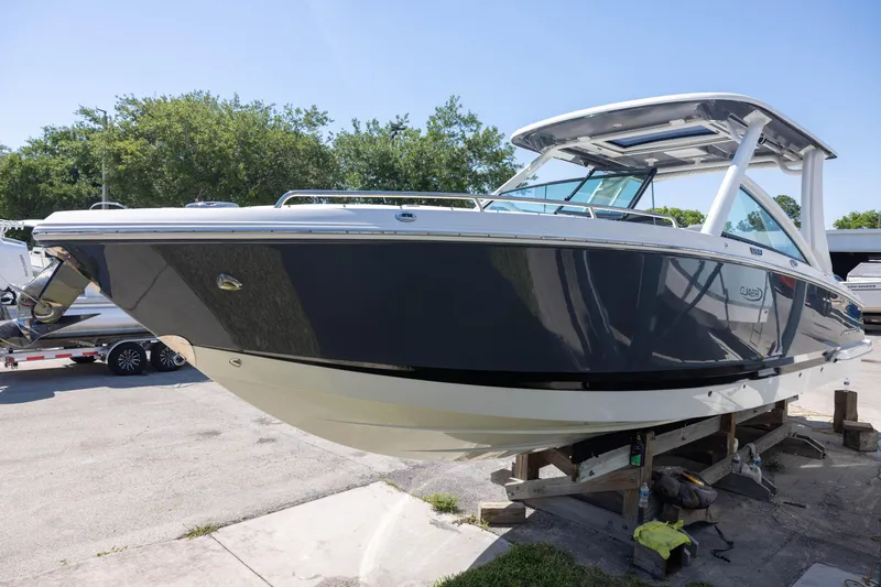 Slide: The Image of 2022 Chaparral 300 OSX boat on display, sleek design, outdoor setting. - 1