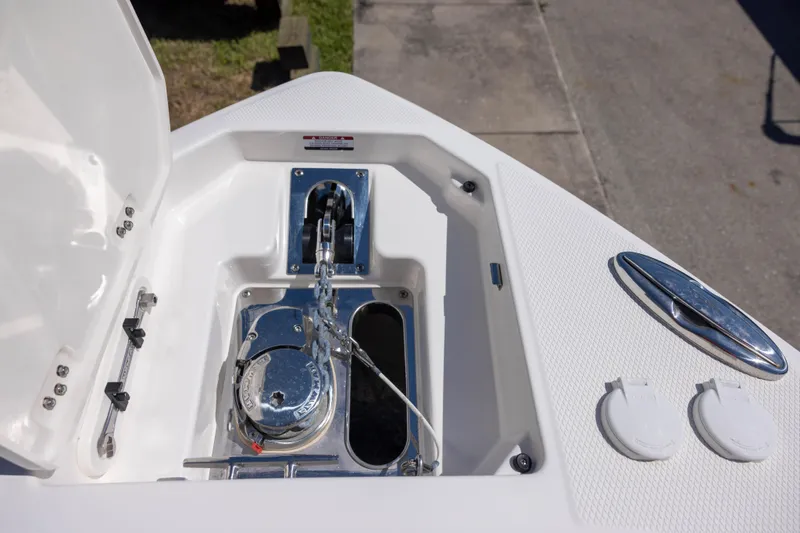 Slide: The Image of Anchor compartment of 2022 Chaparral 300 OSX boat, featuring a polished winch and chain. - 14