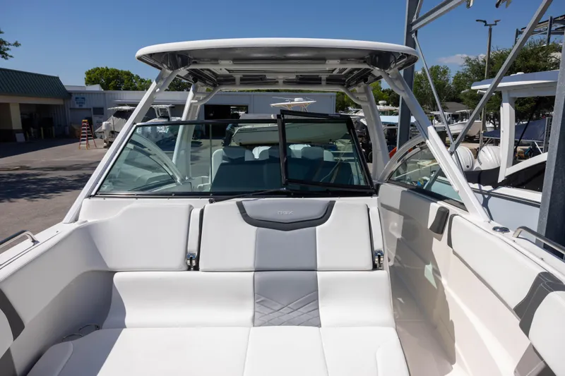 Slide: The Image of 2022 Chaparral 300 OSX boat interior with sleek seating and modern design. - 15