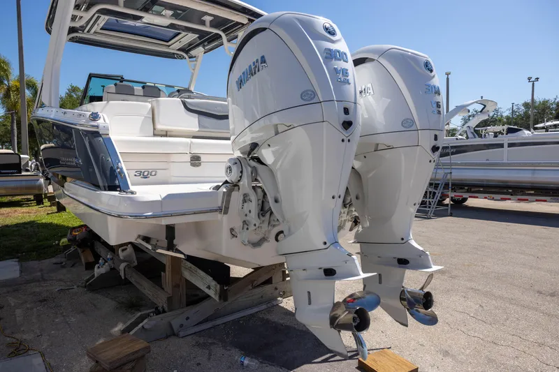 Slide: The Image of 2022 Chaparral 300 OSX boat with dual Yamaha V6 outboard engines displayed outdoors. - 4