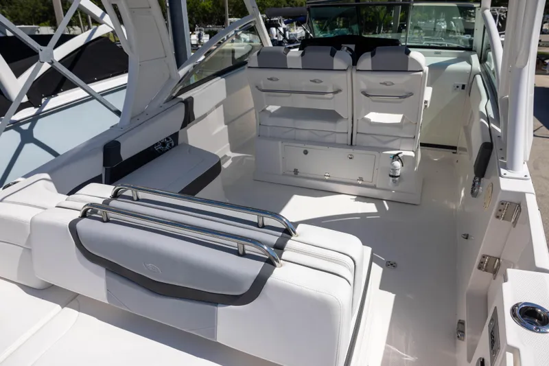 Slide: The Image of 2022 Chaparral 300 OSX boat interior with white seating and modern design. - 5
