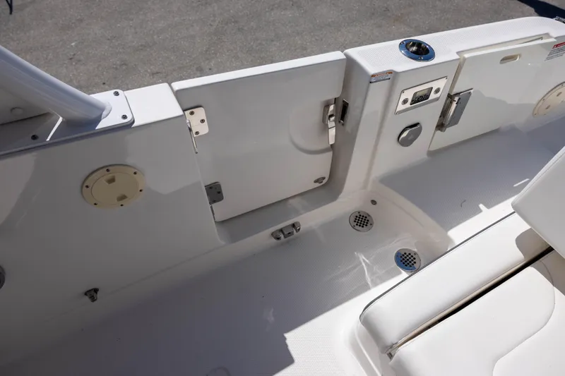 Slide: The Image of 2022 Chaparral 300 OSX boat interior, featuring sleek white seating and deck details. - 8