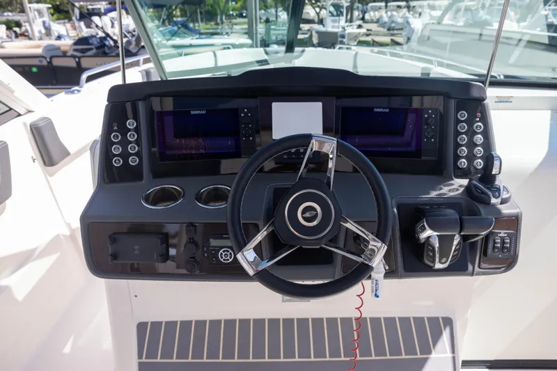 Slide: The Image of 2022 Chaparral 300 OSX helm with advanced controls and navigation displays. - 9