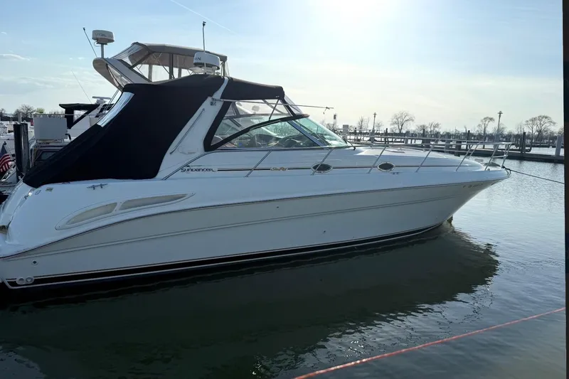 The Image of 2000 Sea Ray 410 Sundancer yacht docked in a marina under clear skies. - 0