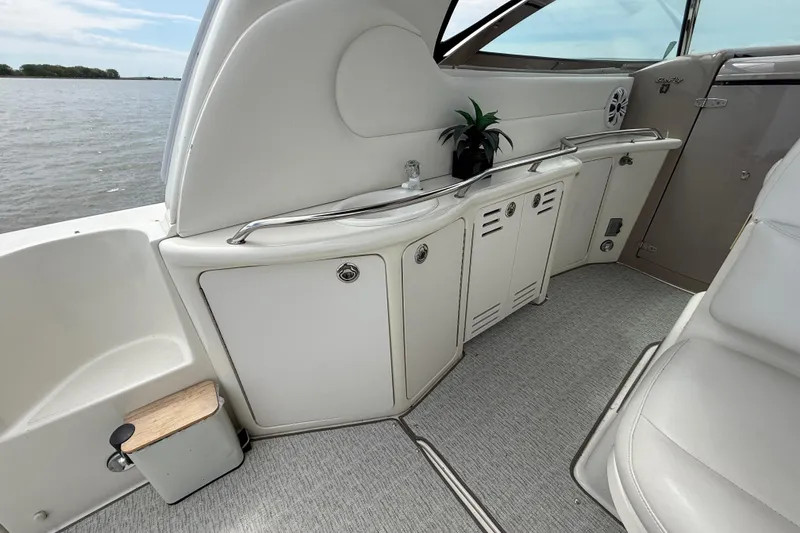 Slide: The Image of Interior view of a 2000 Sea Ray 410 Sundancer yacht with sleek cabinetry and seating. - 11