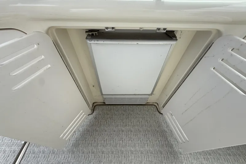 Slide: The Image of Built-in refrigerator on a 2000 Sea Ray 410 Sundancer yacht, with open cabinet doors. - 12