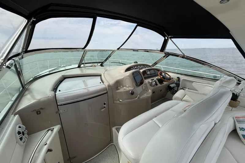 Slide: The Image of Cockpit view of 2000 Sea Ray 410 Sundancer yacht on open water. - 13