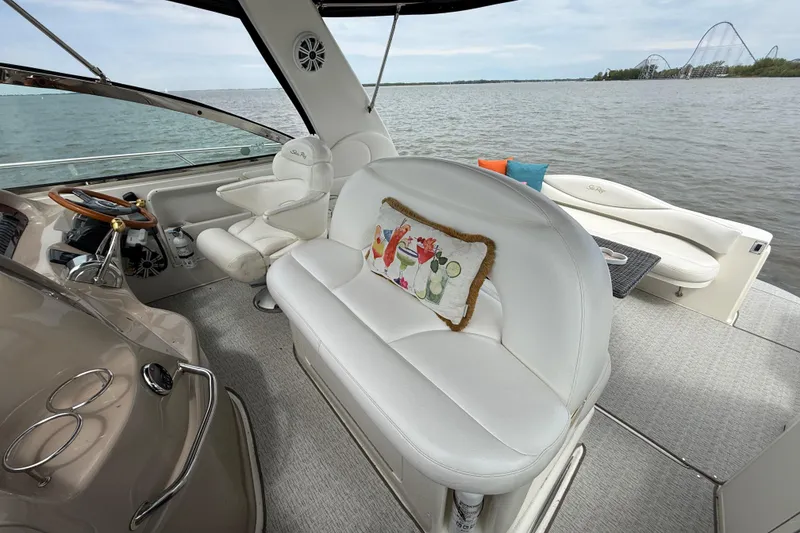 Slide: The Image of Interior of 2000 Sea Ray 410 Sundancer yacht with white seating and scenic water view. - 14