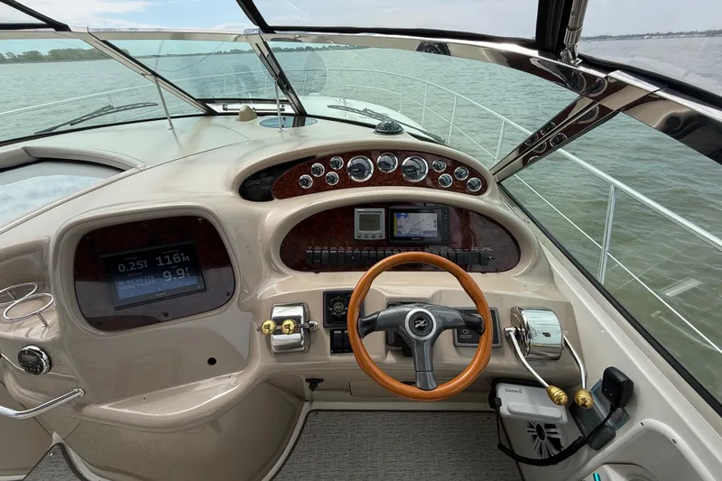 Slide: The Image of Cockpit view of 2000 Sea Ray 410 Sundancer yacht with steering wheel and navigation instruments. - 16