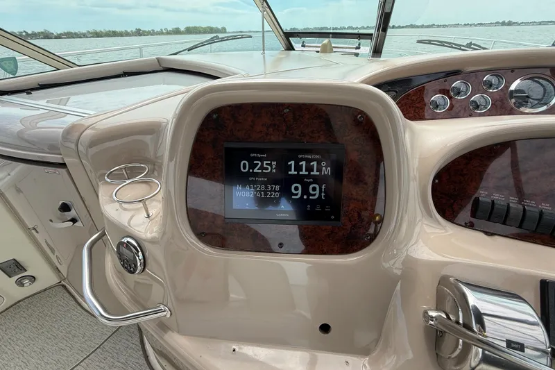 Slide: The Image of Dashboard of a 2000 Sea Ray 410 Sundancer boat with navigation display. - 17