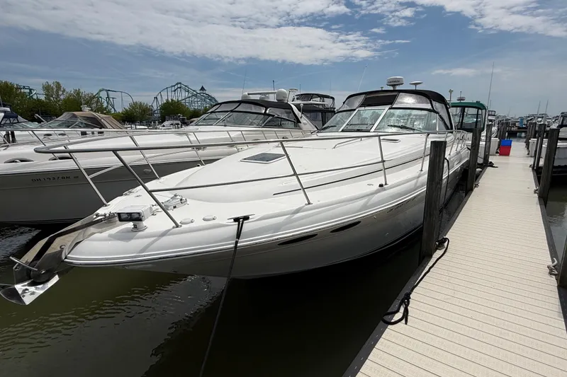 Slide: The Image of 2000 Sea Ray 410 Sundancer yacht docked at marina under partly cloudy sky. - 2