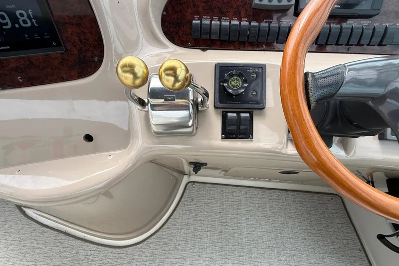 Slide: The Image of Control panel of a 2000 Sea Ray 410 Sundancer with wooden steering wheel and throttle levers. - 20
