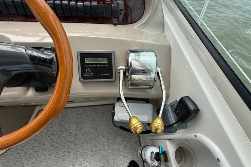 Slide: The Image of Steering wheel and controls of a 2000 Sea Ray 410 Sundancer boat. - 21