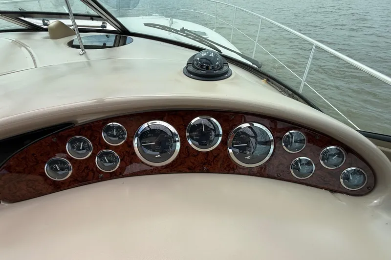 Slide: The Image of Dashboard of a 2000 Sea Ray 410 Sundancer boat with gauges and compass. - 22