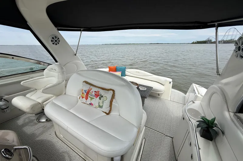 Slide: The Image of Luxurious 2000 Sea Ray 410 Sundancer yacht interior with plush seating and scenic water view. - 24