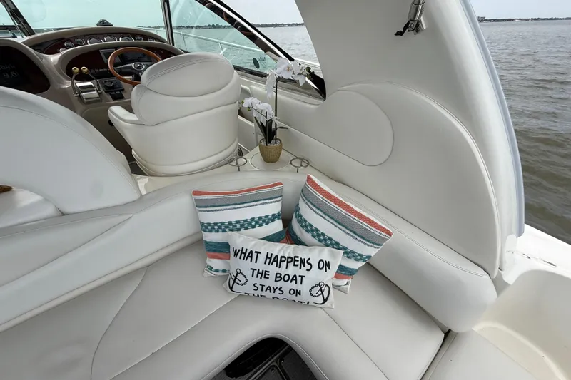 Slide: The Image of Interior of 2000 Sea Ray 410 Sundancer with decorative pillows and helm view. - 25