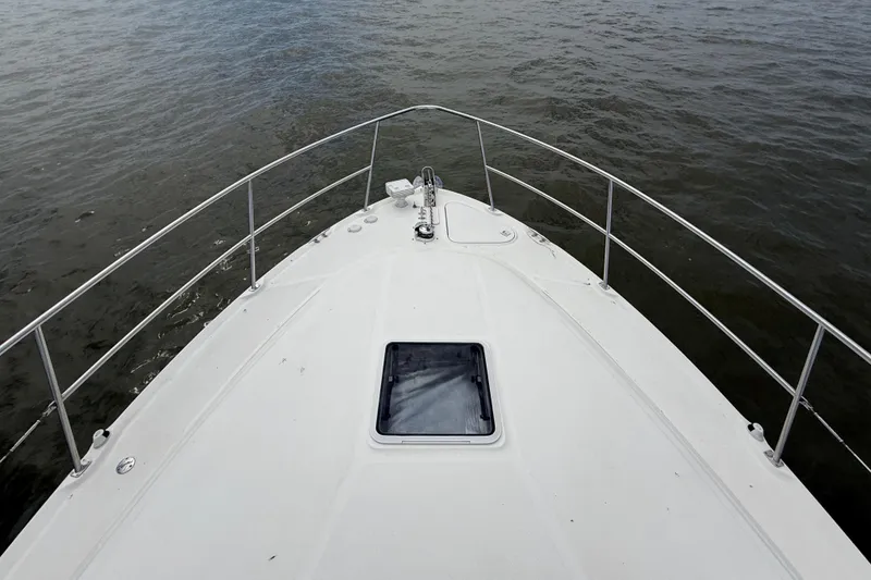 Slide: The Image of Bow view of 2000 Sea Ray 410 Sundancer yacht on calm waters. - 28
