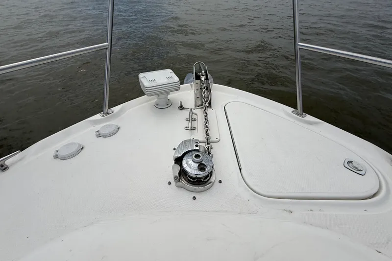 Slide: The Image of Bow of 2000 Sea Ray 410 Sundancer with anchor chain and railing, overlooking water. - 29
