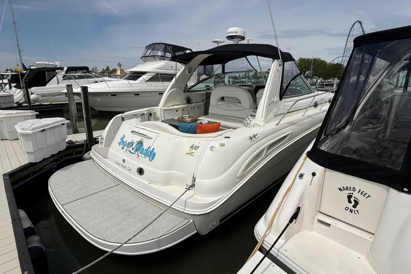 Slide: The Image of 2000 Sea Ray 410 Sundancer docked at marina, featuring sleek design and spacious deck. - 3