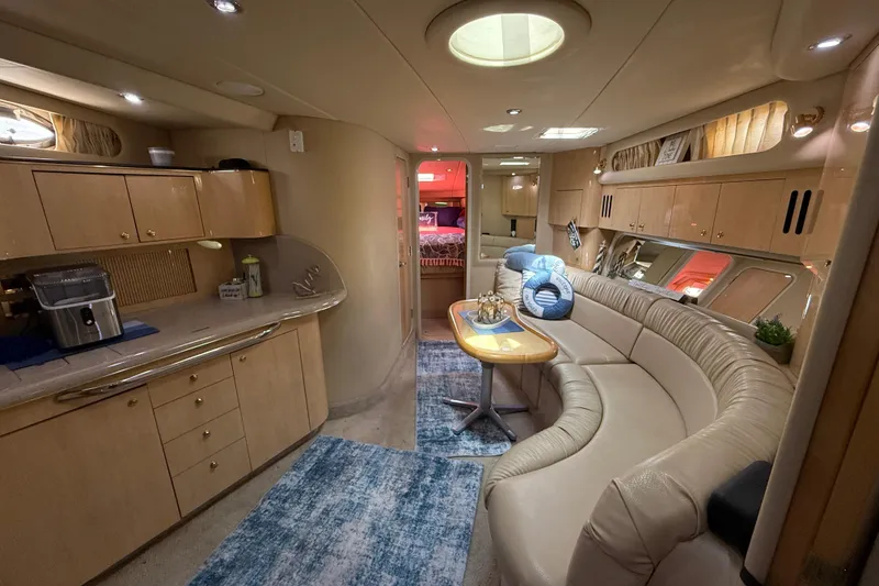 Slide: The Image of Luxurious interior of a 2000 Sea Ray 410 Sundancer yacht with elegant seating and modern amenities. - 30
