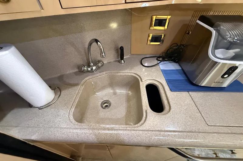 Slide: The Image of Kitchen sink area on a 2000 Sea Ray 410 Sundancer yacht with paper towel holder. - 34