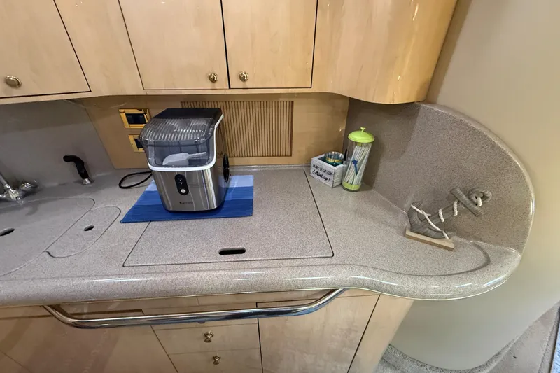 Slide: The Image of Kitchen area of 2000 Sea Ray 410 Sundancer yacht with countertop appliances. - 35