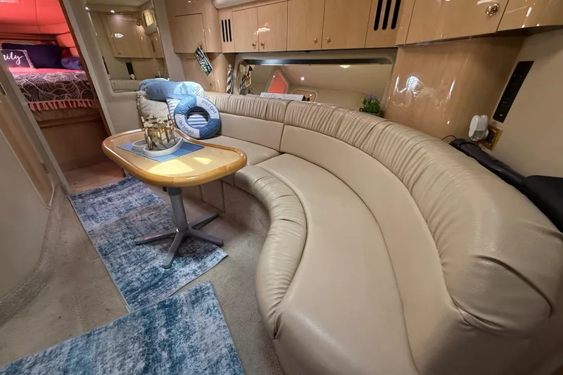 Slide: The Image of Luxurious interior of 2000 Sea Ray 410 Sundancer yacht with curved seating and elegant decor. - 37