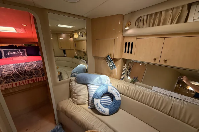 Slide: The Image of Interior of 2000 Sea Ray 410 Sundancer yacht with cozy seating and nautical decor. - 38