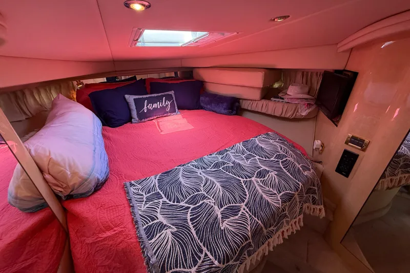 Slide: The Image of Cozy cabin interior of 2000 Sea Ray 410 Sundancer with red bedding and decorative pillows. - 41