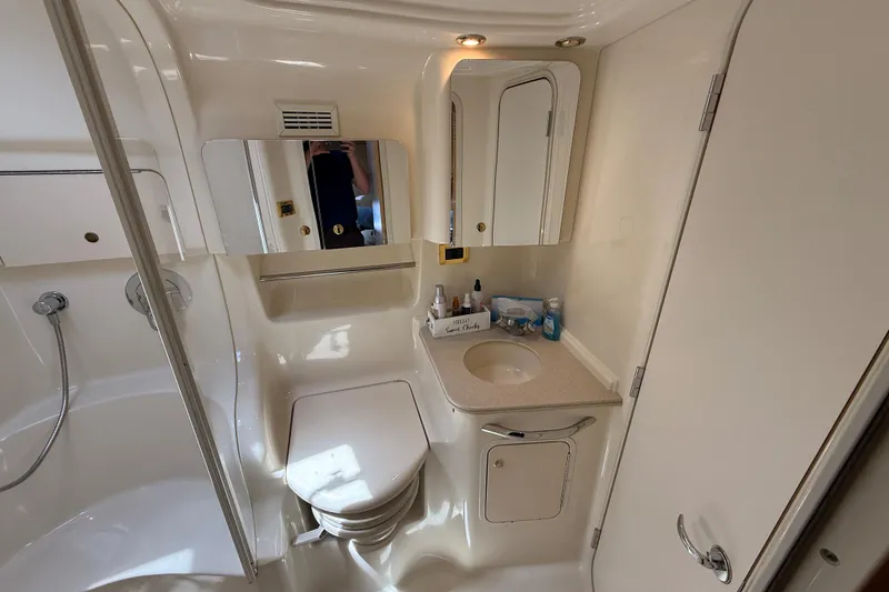 Slide: The Image of Bathroom interior of 2000 Sea Ray 410 Sundancer yacht, featuring sink and toilet. - 44