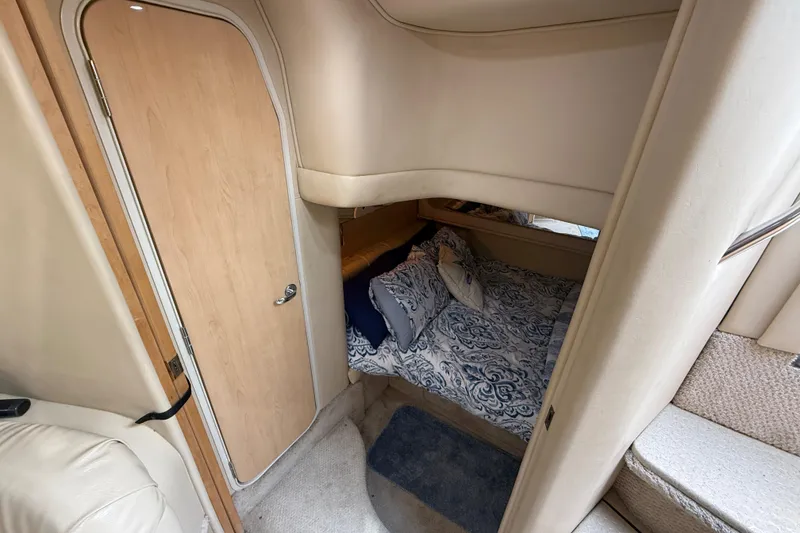 Slide: The Image of Interior cabin of 2000 Sea Ray 410 Sundancer with cozy bed and wooden door. - 45