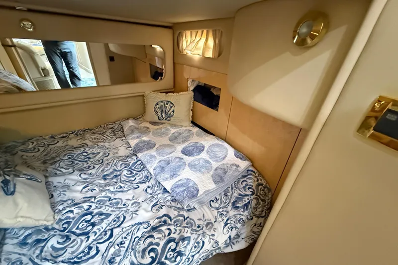 Slide: The Image of Cozy cabin interior of 2000 Sea Ray 410 Sundancer with nautical-themed bedding. - 48