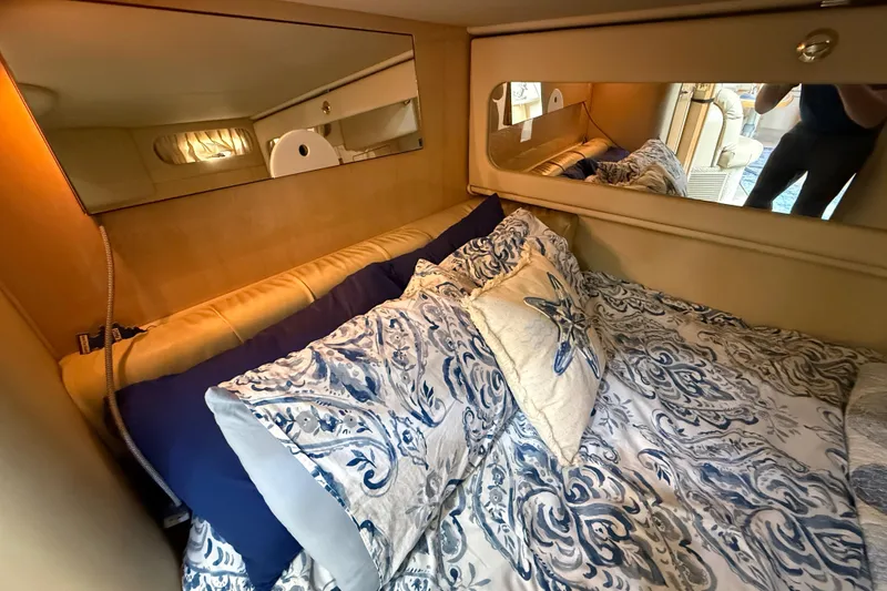 Slide: The Image of Luxurious cabin interior of 2000 Sea Ray 410 Sundancer with elegant bedding and mirrored walls. - 49