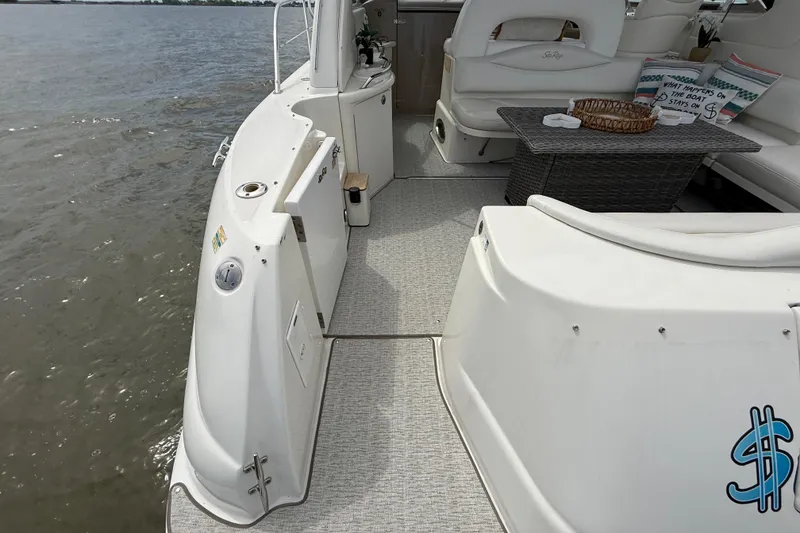 Slide: The Image of 2000 Sea Ray 410 Sundancer yacht deck with seating and table, overlooking water. - 5