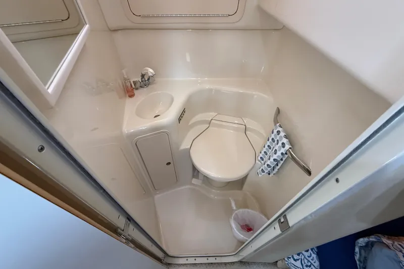 Slide: The Image of Bathroom interior of 2000 Sea Ray 410 Sundancer yacht, featuring compact design and amenities. - 51