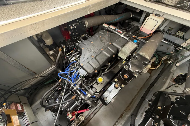 Slide: The Image of Engine compartment of a 2000 Sea Ray 410 Sundancer boat, showcasing mechanical components. - 53