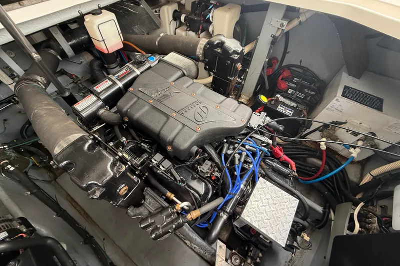 Slide: The Image of Engine compartment of a 2000 Sea Ray 410 Sundancer, showcasing detailed mechanical components. - 54