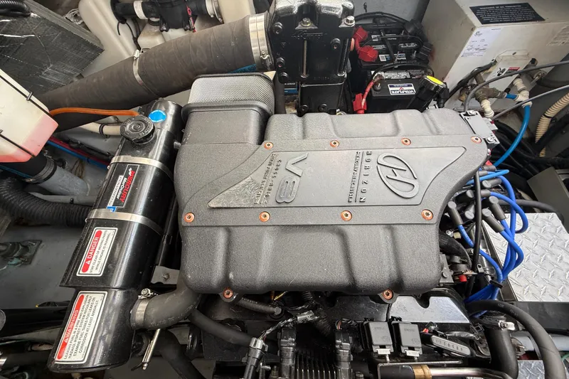 Slide: The Image of Engine compartment of a 2000 Sea Ray 410 Sundancer boat, featuring a V8 engine. - 56