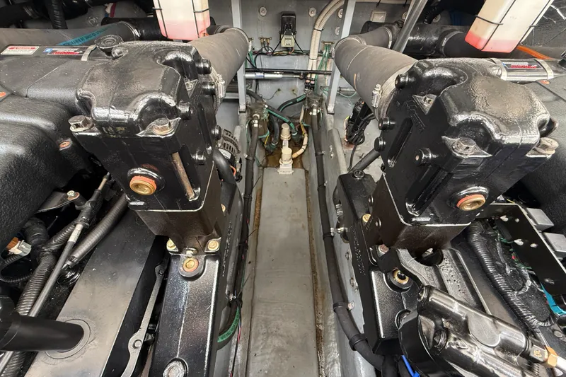Slide: The Image of Engine room of a 2000 Sea Ray 410 Sundancer, showcasing dual engines and components. - 57