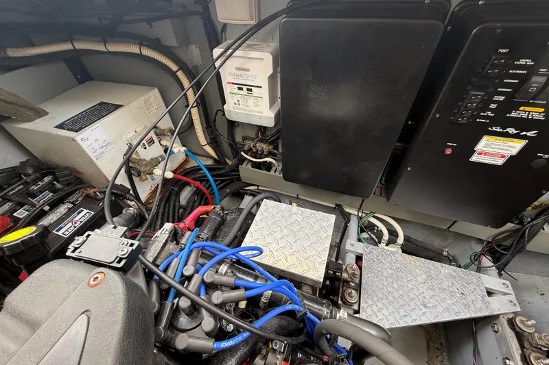 Slide: The Image of Engine compartment of a 2000 Sea Ray 410 Sundancer with electrical components and wiring. - 59