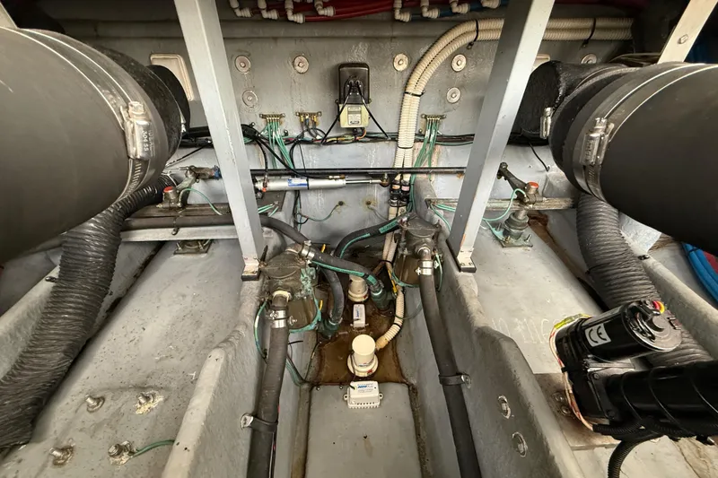 Slide: The Image of Engine compartment of a 2000 Sea Ray 410 Sundancer, showcasing hoses and wiring. - 60