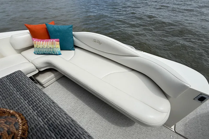 Slide: The Image of Luxurious seating on 2000 Sea Ray 410 Sundancer with colorful cushions, overlooking water. - 8