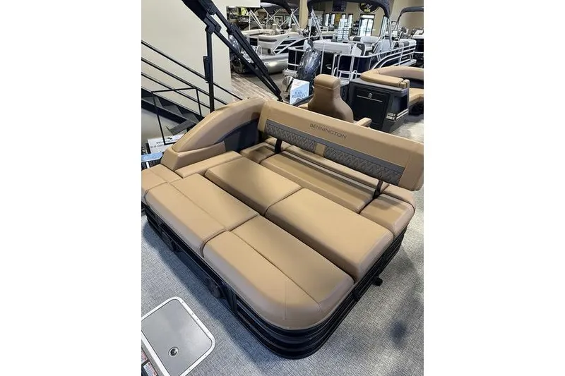 Slide: The Image of 2026 Bennington M Swingback 22 MSB boat interior with tan seating in showroom. - 11