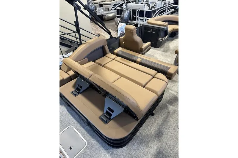 Slide: The Image of 2026 Bennington M Swingback 22 MSB boat interior with tan seating and adjustable backrest. - 12