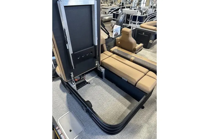Slide: The Image of 2026 Bennington M Swingback 22 MSB interior with open storage compartment and tan seating. - 16